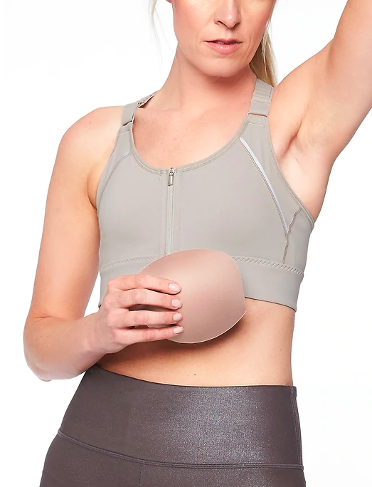 Women holding an empower pad while wearing her Athleta Empower Bra