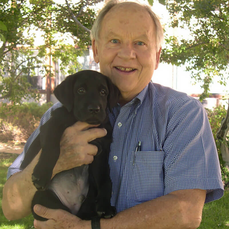 Old man holding canine dog